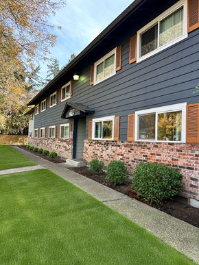 Beaverton apartment for rent - A house with a grey siding and a brick wall.