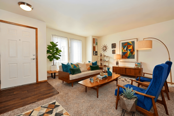 Oregon City apartment for rent - A living room with a blue chair and a wooden bench.