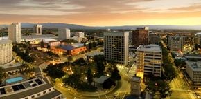 San Jose apartment for rent - A cityscape at dusk with buildings and a pool.