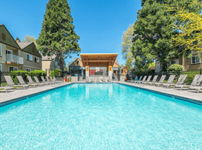 Vancouver apartment for rent - a swimming pool with chaise lounge chairs and a clubhouse in the background