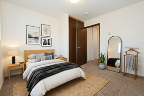Portland apartment for rent - A bedroom with a large bed and a mirror on the wall.