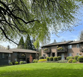 Portland apartment for rent - Apartment complex with green lawn and trees.