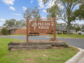 Dublin apartment for rent - A sign for Pecan Ridge Apartment Homes is in front of a building.