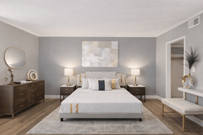 Eagan apartment for rent - A bedroom with a large bed, nightstands, and a bench.