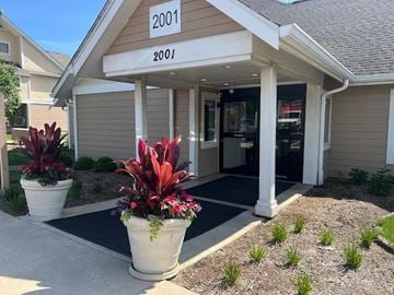 Lombard apartment for rent - A building with the number 2001 on it has a red plant in a white pot in front of it.