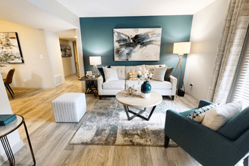 Vestavia Hills apartment for rent - A living room with a white couch, a coffee table, and a large abstract painting on the wall.
