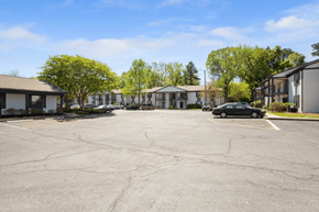 Hoover apartment for rent - A parking lot with a car parked in front of a building with a white facade.