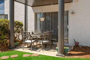 Hoover apartment for rent - A patio with a table and chairs is covered by a white awning.