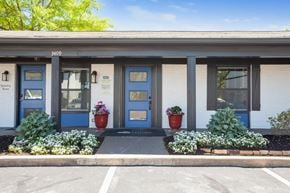 Hoover apartment for rent - A white building with blue doors and windows has a sign that says 3409 on it.