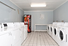 Hoover apartment for rent - A laundromat with a Coca-Cola machine in the corner.