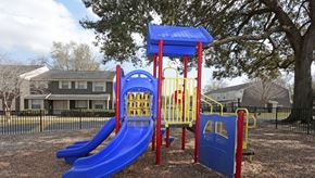 Jacksonville apartment for rent - a playground with slides and swings at a park