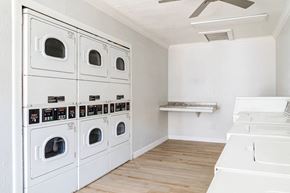 Jacksonville apartment for rent - A row of white front loading washing machines in a laundry room.
