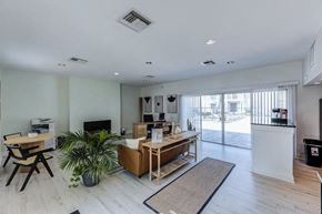 Jacksonville apartment for rent - A living room with a white ceiling and a large window.