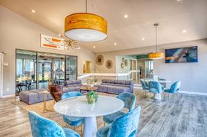 St Petersburg apartment for rent - A modern dining room with a glass table and blue chairs.