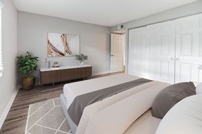 St Petersburg apartment for rent - A bedroom with a large bed and a wooden cabinet.