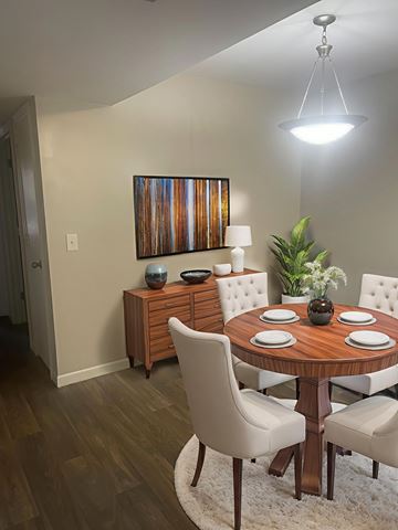 Rome apartment for rent - A dining room with a wooden table and white chairs.