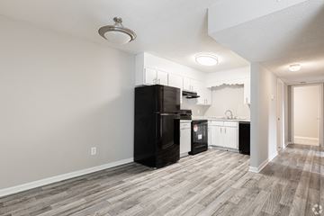 Dublin apartment for rent - A kitchen with black appliances and wooden flooring.
