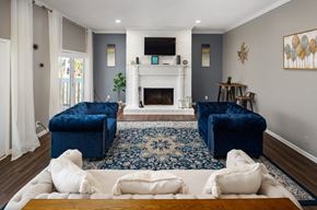 Macon apartment for rent - a living room with two blue couches and a fireplace