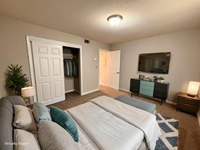 Athens apartment for rent - A bedroom with two beds and a dresser with a mirror above it.