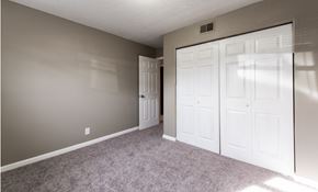 Louisville apartment for rent - A room with a carpeted floor and white doors.