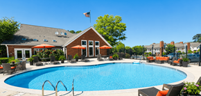 Birmingham apartment for rent - A pool with a red umbrella and a building in the background.