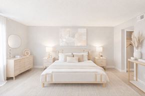Lombard apartment for rent - A white bedroom with a large bed, nightstands, and a painting on the wall.