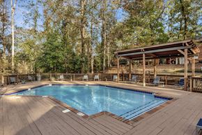 Birmingham apartment for rent - a resort style swimming pool with a wooden deck and a pool pavilion