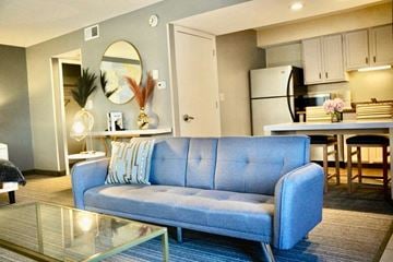 Lombard apartment for rent - A blue couch is in the middle of a living room.
