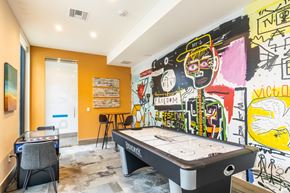 Davie apartment for rent - a game room with a pool table and graffiti on the wall