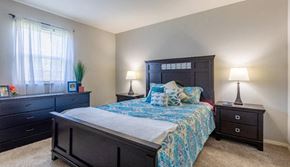 Evansville apartment for rent - a bedroom with a bed and two dressers