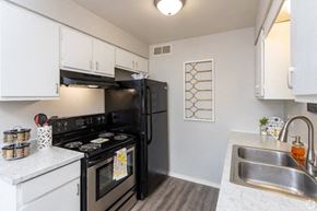 Evansville apartment for rent - a kitchen with a stove refrigerator and sink