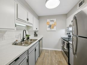 Macon apartment for rent - an apartment kitchen with stainless steel appliances and white cabinets