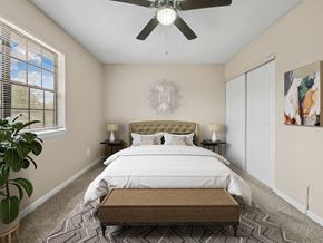 Dublin townhouse for rent - a bedroom with a large bed and a ceiling fan