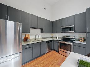 Macon apartment for rent - a kitchen with stainless steel appliances and gray cabinets