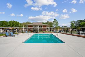 Valdosta apartment for rent - a swimming pool with a building in the background