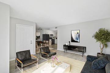 Dublin townhouse for rent - A living room with a black couch and a painting on the wall.