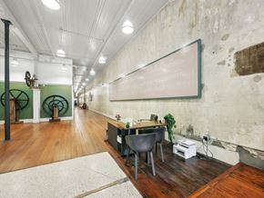 Macon apartment for rent - a conference room with a desk and chairs and a chalkboard on the wall