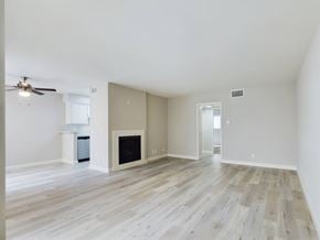 Encino apartment for rent - Apartments in Encino, CA - Living Room with Firepalce and Dining Room with Ceiling Fan
