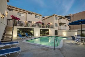 Encino apartment for rent - Apartments in Encino, CA - Pool with Lounge Chairs and Building Exteriors Lit Up at Night