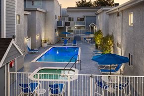 Encino apartment for rent - Apartments in Encino, CA Elevated View of Pool  Patio with Lounge Chairs Jacuzzi Umbrella Tables and Apartment Buildings Lit Up at Night