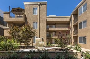 Sherman Oaks apartment for rent - Apartments in Sherman Oaks, CA - Courtyard Art and Foliage with Surrounding Apartment Buildings