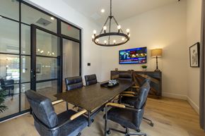 Spring apartment for rent - a dining room with a table and chairs and a tv