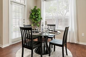 Katy apartment for rent - A dining room with a table set for two and a potted plant.