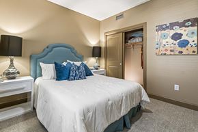 San Antonio apartment for rent - A bedroom with a bed, nightstand, and lamp.