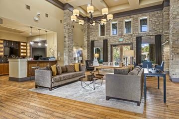 San Antonio apartment for rent - A living room with a grey couch and a wooden floor.