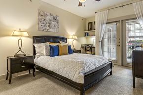 San Antonio apartment for rent - A bedroom with a large bed and a ceiling fan.