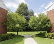 Montvale apartment for rent - a walkway between two buildings with trees in the background at Nottingham Manor Apartments, Montvale, NJ