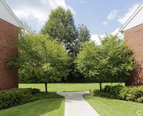 Montvale apartment for rent - a walkway between two buildings with trees in the background at Nottingham Manor Apartments, Montvale, NJ