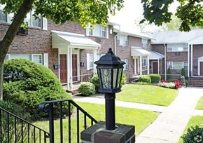 Teaneck apartment for rent - a lamp post in front of a brick buildingat Willow Gardens Apartments, New Jersey, 07666