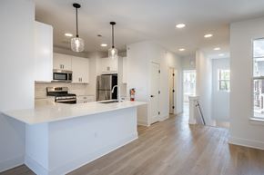 Somerville apartment for rent - A modern kitchen with white cabinets and a large island.